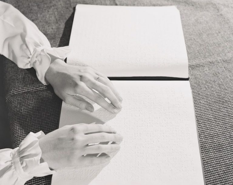 Braille reading Hands resting on an open braille book reading a specific page.