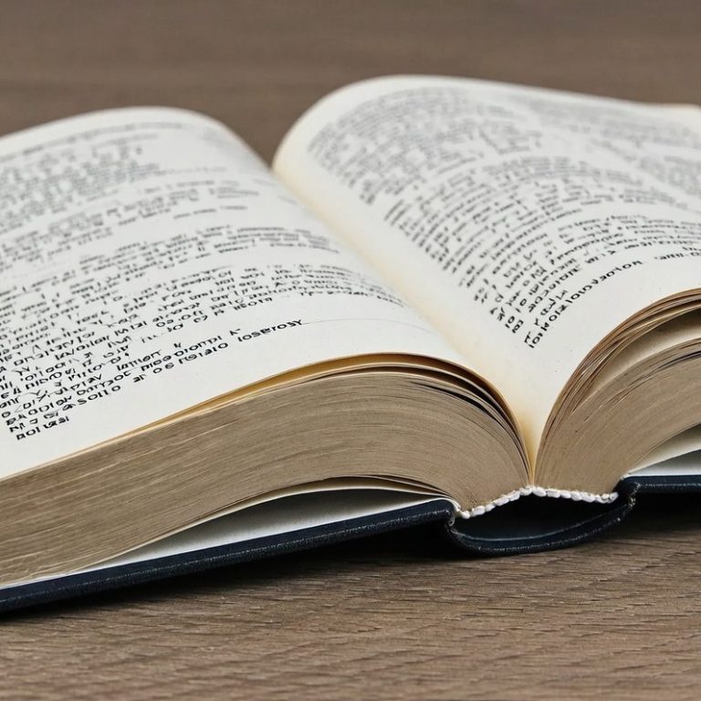 Picture of printed book Open book on a wooden surface, pages visible, with printed text.